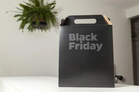 Black Friday gift box on the table with black packaging with writing in dark  스톡 사진