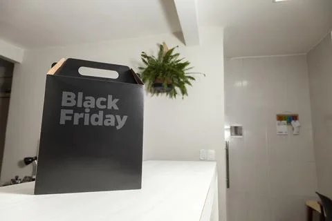 Black Friday gift box on the table with black packaging with writing in dark  Фото
