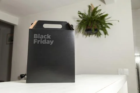 Black Friday gift box on the table with black packaging with writing in dark  Photos