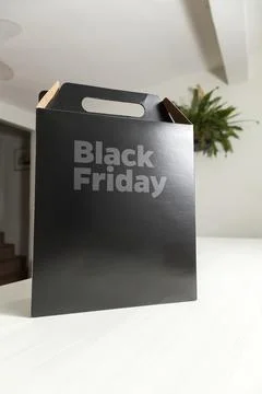 Black Friday gift box on the table with black packaging with writing in dark  스톡 사진