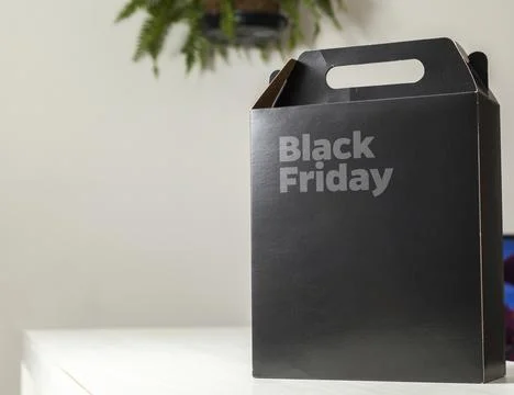 Black Friday gift box on the table with black packaging with writing in dark  Fotos Stock