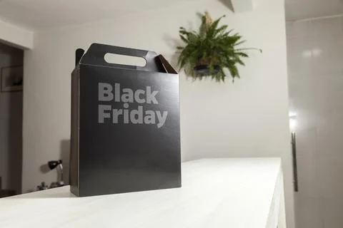 Black Friday gift box on the table with black packaging with writing in dark  Fotos de archivo