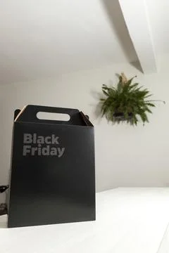 Black Friday gift box on the table with black packaging with writing in dark  Fotos de archivo