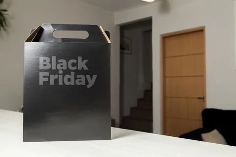 Black Friday gift box on the table with black packaging with writing in dark  Fotos de archivo