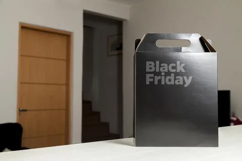 Black Friday gift box on the table with black packaging with writing in dark  Fotos de archivo