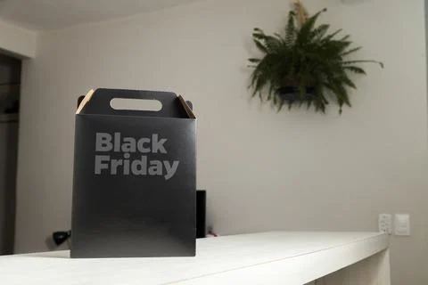 Black Friday gift box on the table with black packaging with writing in dark  Фото