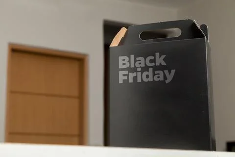 Black Friday gift box on the table with black packaging with writing in dark  Fotos de archivo