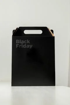 Black Friday gift box on the table with black packaging with writing in dark  Фото
