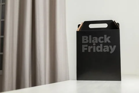 Black Friday gift box on the table with black packaging with writing in dark  스톡 사진
