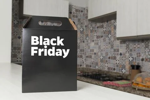 Black Friday gift box on the table with black packaging with writing in dark  Fotos Stock
