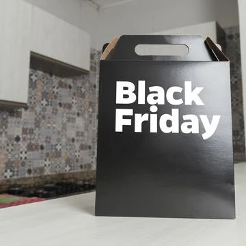 Black Friday gift box on the table with black packaging with writing in dark  库存照片