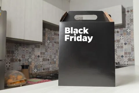 Black Friday gift box on the table with black packaging with writing in dark  Фото