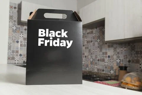 Black Friday gift box on the table with black packaging with writing in dark  스톡 사진