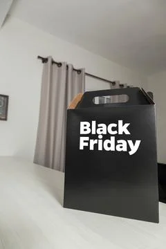 Black Friday gift box on the table with black packaging with writing in dark  Fotos Stock