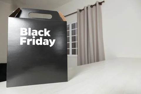 Black Friday gift box on the table with black packaging with writing in dark  Фото