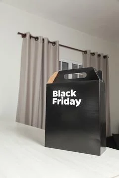 Black Friday gift box on the table with black packaging with writing in dark  Photos