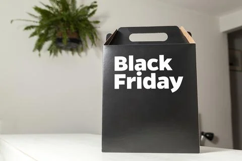 Black Friday gift box on the table with black packaging with writing in dark  Photos