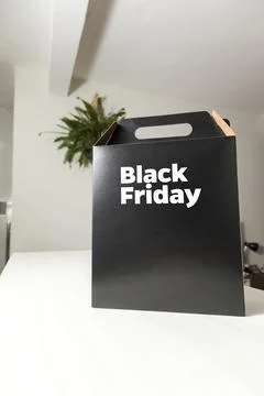 Black Friday gift box on the table with black packaging with writing in dark  Фото