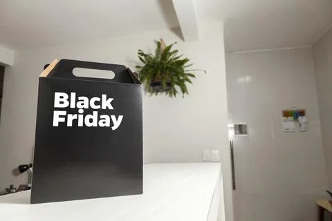 Black Friday gift box on the table with black packaging with writing in dark  Stock-Fotos