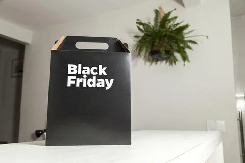 Black Friday gift box on the table with black packaging with writing in dark  Фото