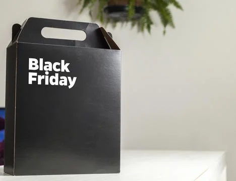 Black Friday gift box on the table with black packaging with writing in dark  Photos