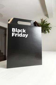 Black Friday gift box on the table with black packaging with writing in dark  Fotos Stock