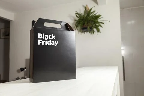 Black Friday gift box on the table with black packaging with writing in dark  Fotos de archivo