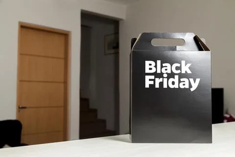 Black Friday gift box on the table with black packaging with writing in dark  Fotos de archivo