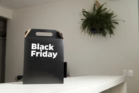 Black Friday gift box on the table with black packaging with writing in dark  Photos