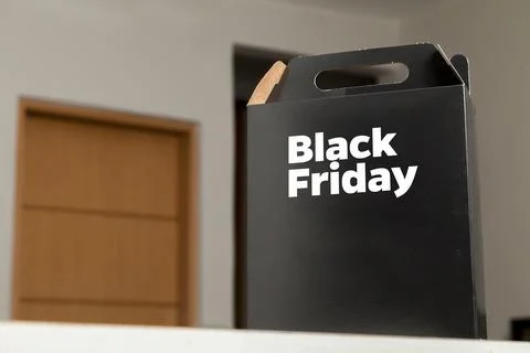 Black Friday gift box on the table with black packaging with writing in dark  Stock-Fotos