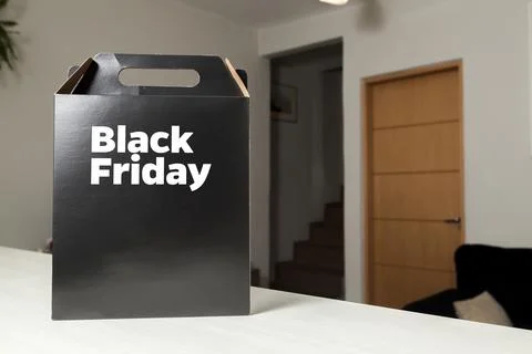 Black Friday gift box on the table with black packaging with writing in dark  Fotos de archivo
