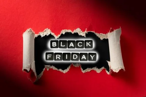 Black Friday glow effect inside torn red paper. Stock Photos