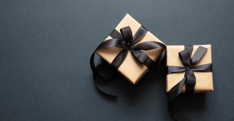 Black Friday sale concept. Gift boxes with black ribbon isolated against blac Stock Photos
