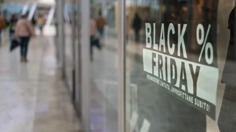 Black friday sign on store display background in a mall with people walking Stock Footage 147035060