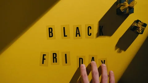Black Friday on a yellow background with freebies during the discount party Stock Footage 320391320