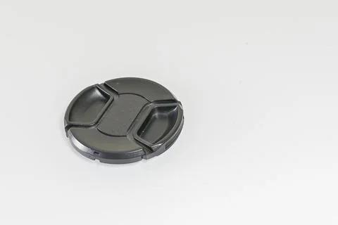 Black front lens cap on a white background Stock Photos