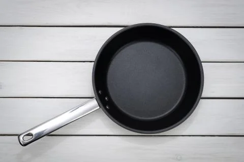 Black fry pan on the table Stock Photos
