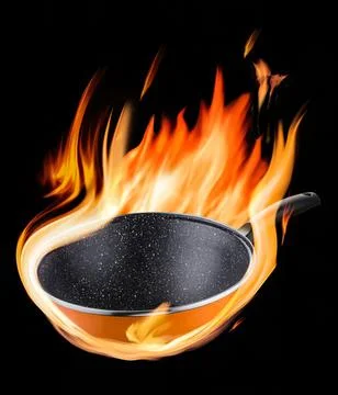 Black frying pan with fire flames on a dark background Stock Photos