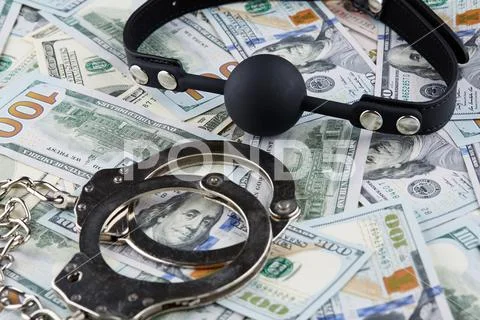 Black gag and handcuffs on american dollars banknotes Stock Photos