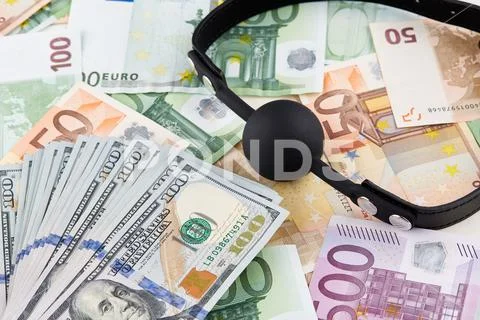 Black gag and heap of american dollars on euro banknotes Stock Photos