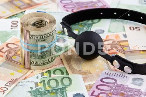 Black gag and roll of american dollars on euro banknotes Stock Photos