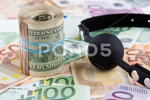 Black gag and roll of american dollars on euro banknotes Stock Photos