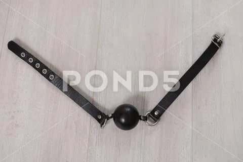 Black gag on the wooden floor Stock Photos