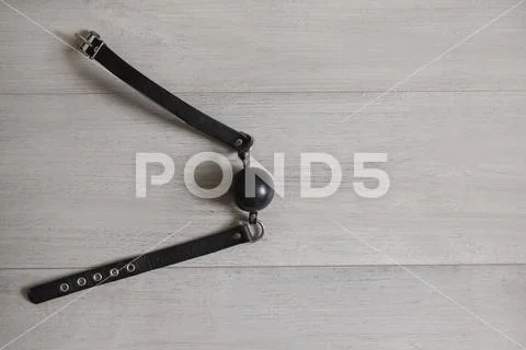 Black gag on the wooden floor Stock Photos