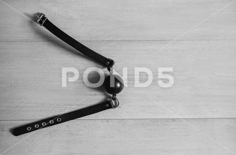 Black gag on the wooden floor Stock Photos