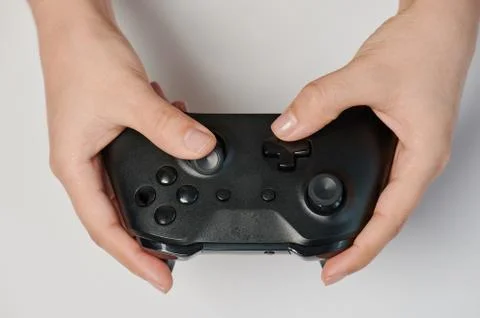 Black game controller in hand Stock Photos