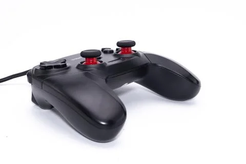 Black Game Controller with Red Buttons on White Background, Gaming Accessory. Stock Photos