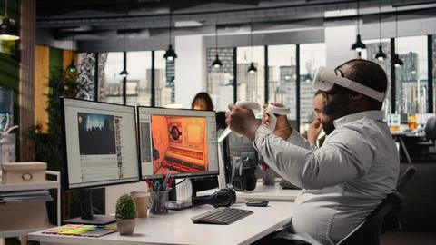 Black game developer designing assets with VR headset at the office Stock Photos