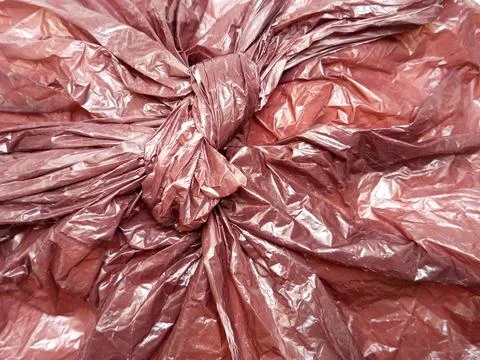 Black garbage bag knot background. Real High-Density Polyethylene shopping bag Stock Photos
