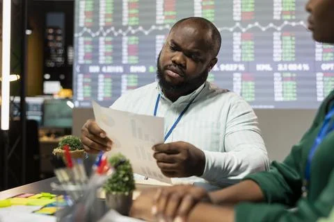 Black general director looking into statistics and reports to detect any 스톡 사진